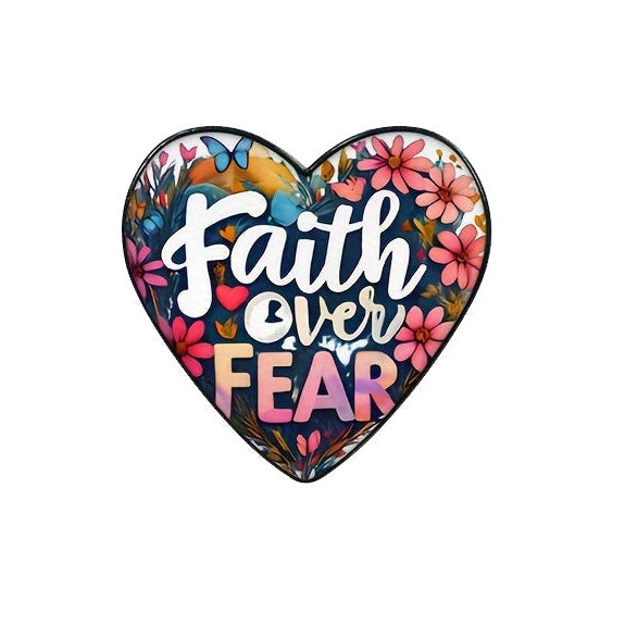 A heart-shaped enamel pin with a floral pattern and the inscription 'Faith Over Fear' in the center.