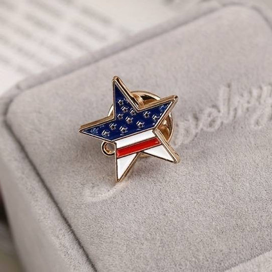 A gold-colored star-shaped enamel pin with the American flag design embedded in the center