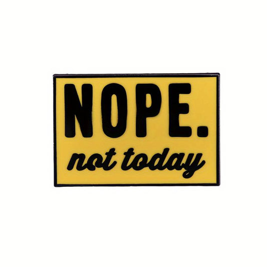 An enamel pin with a yellow backing and black text that reads 'NOPE. Not Today'.